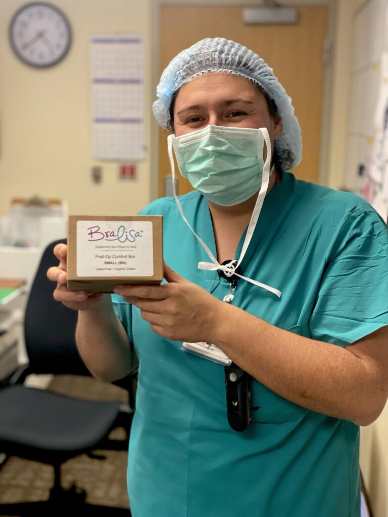 A surgical nurse holding a a box with BraLisa logo on the front