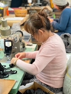 Woman sewing on the factory floor