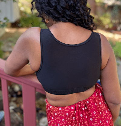 A back view of a woman wearing BraLisa's seamless, wireless, organic cotton bra with full back coverage and adjustable straps; for breast surgery recovery and women seeking a true comfort bra.