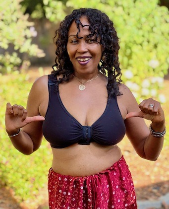 A woman confidently wearing BraLisa's seamless, wireless, organic cotton bra with front closure and adjustable straps; for breast surgery recovery and women seeking a true comfort bra.