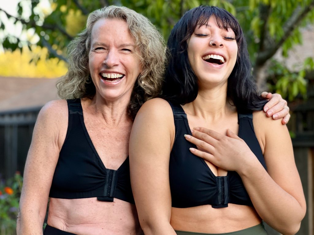 Two laughing women wearing BraLisa's seamless, wireless, organic cotton bra with front closure and adjustable straps; for breast surgery recovery and women seeking a true comfort bra.